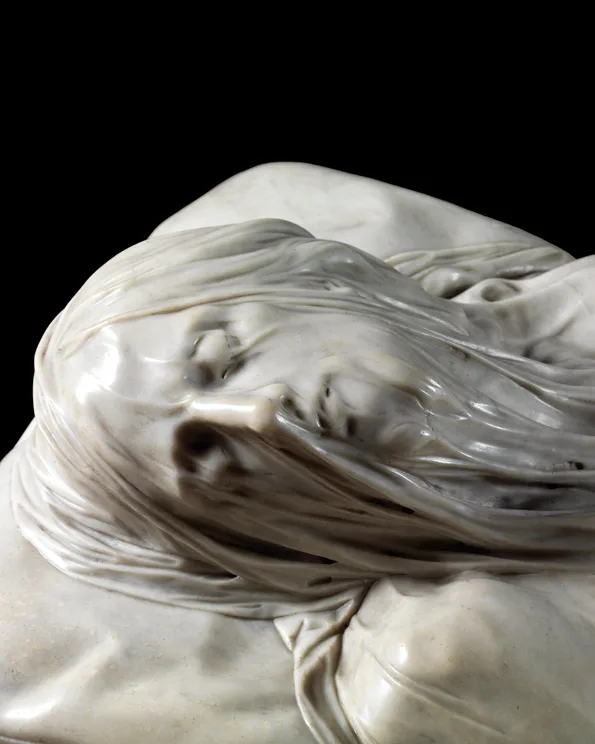 The face of the Veiled Christ seen through the carved marble shroud